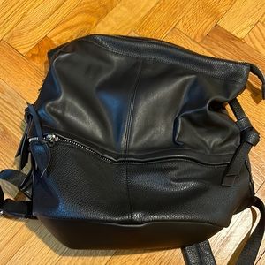 Black vegan leather bag that doubles as a bag and backpack